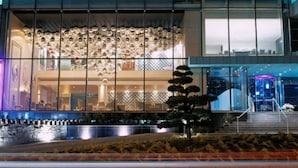 A modern building with large windows and a well-lit entrance.