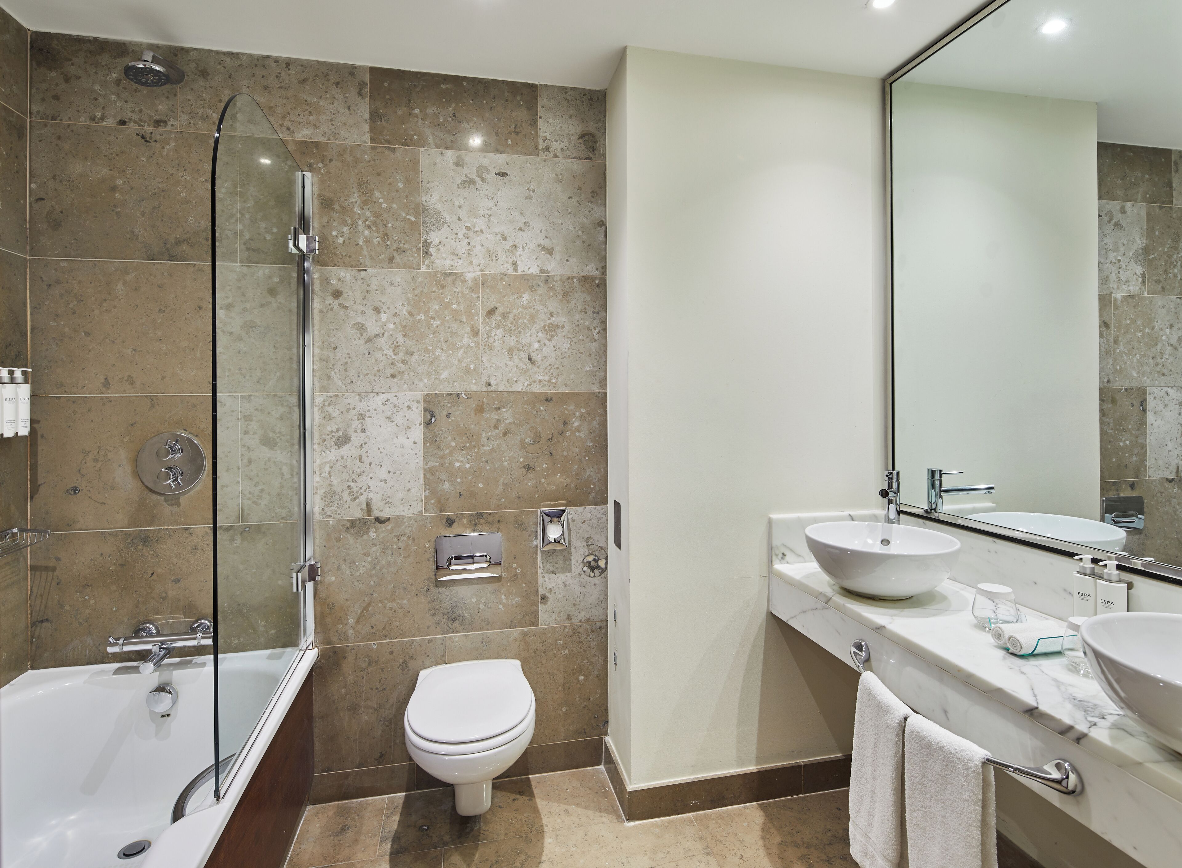 combined shower/bathtub, bathrobes, slippers, towels