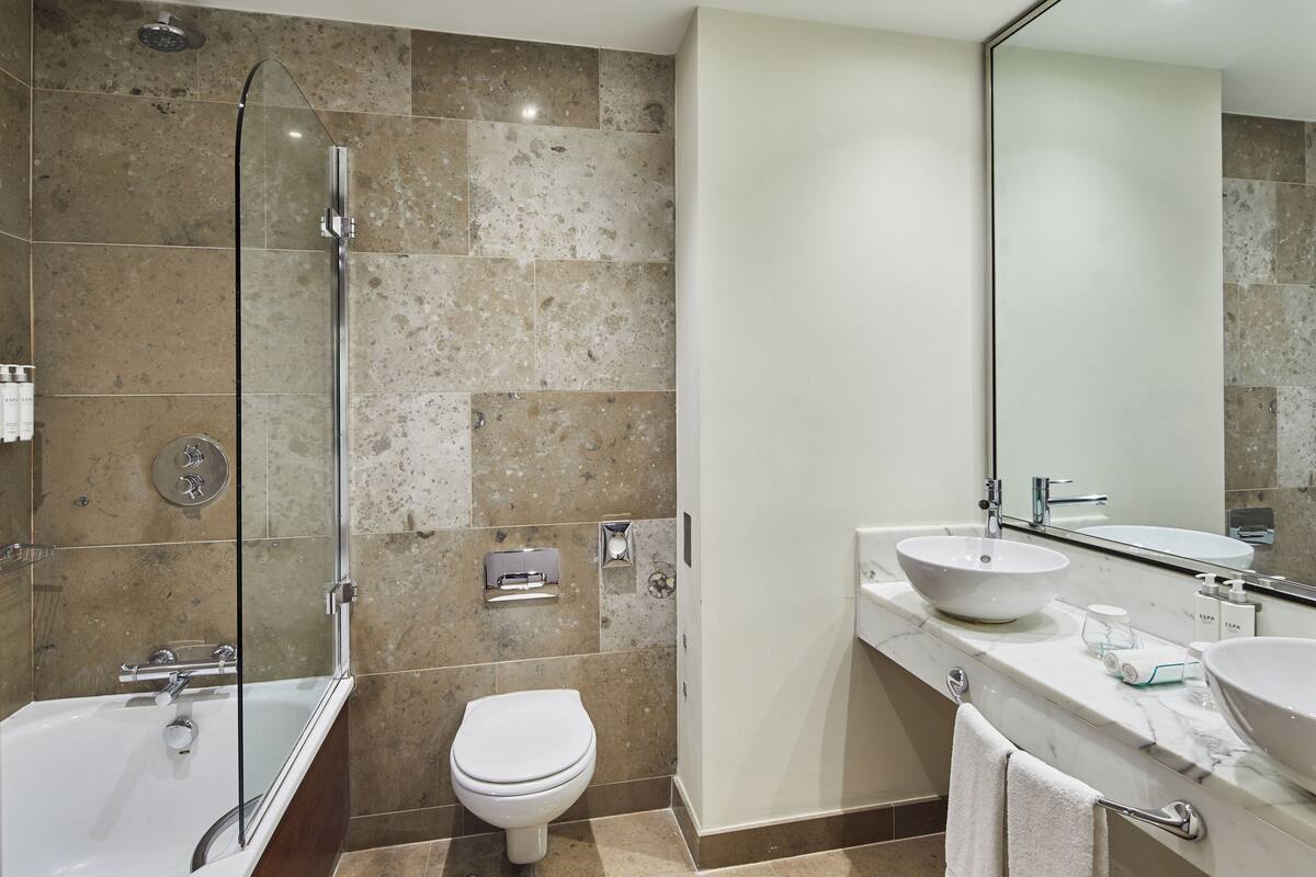 combined shower/bathtub, bathrobes, slippers, towels