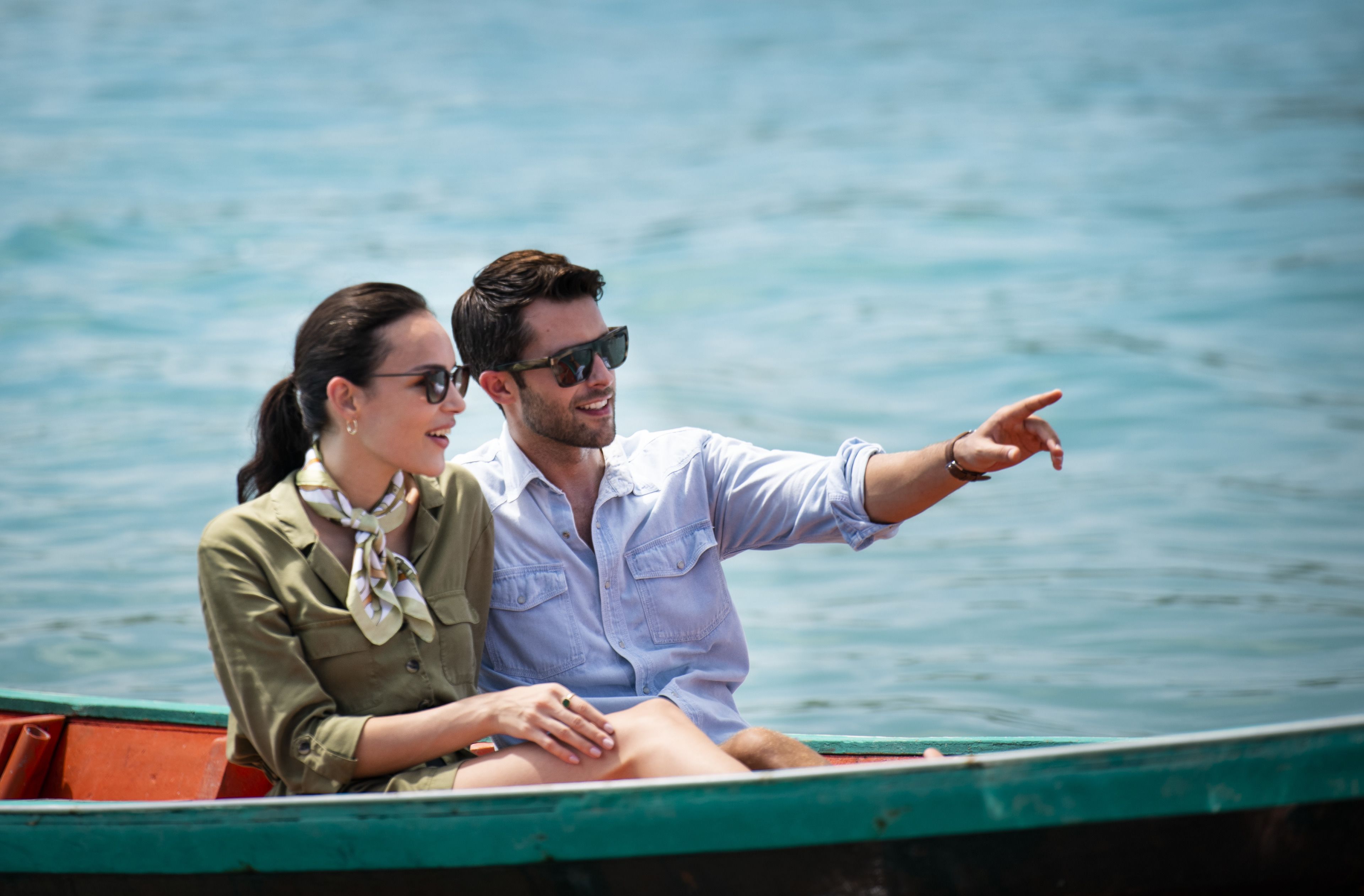 A couple on a boat with a view of the water.
