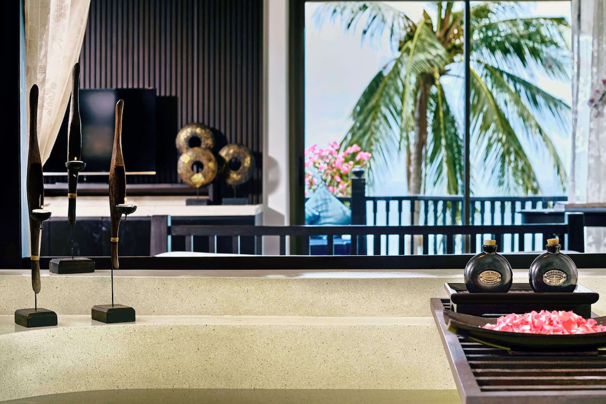 A modern kitchen with a large window, a grill, and decorative items.