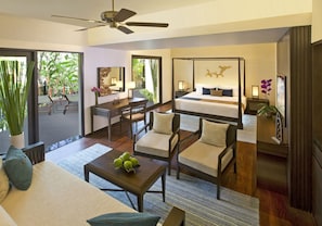 A modern hotel room with a four-poster bed, a desk with a chair, a sofa, and a dining area with a table and chairs. - Anantara Bophut Koh Samui Resort (Koh Samui)