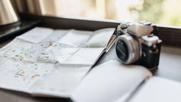 Una cámara sobre una mesa con un mapa y un cuaderno.