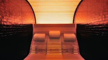A tunnel-like interior with brick walls and a reflective floor.