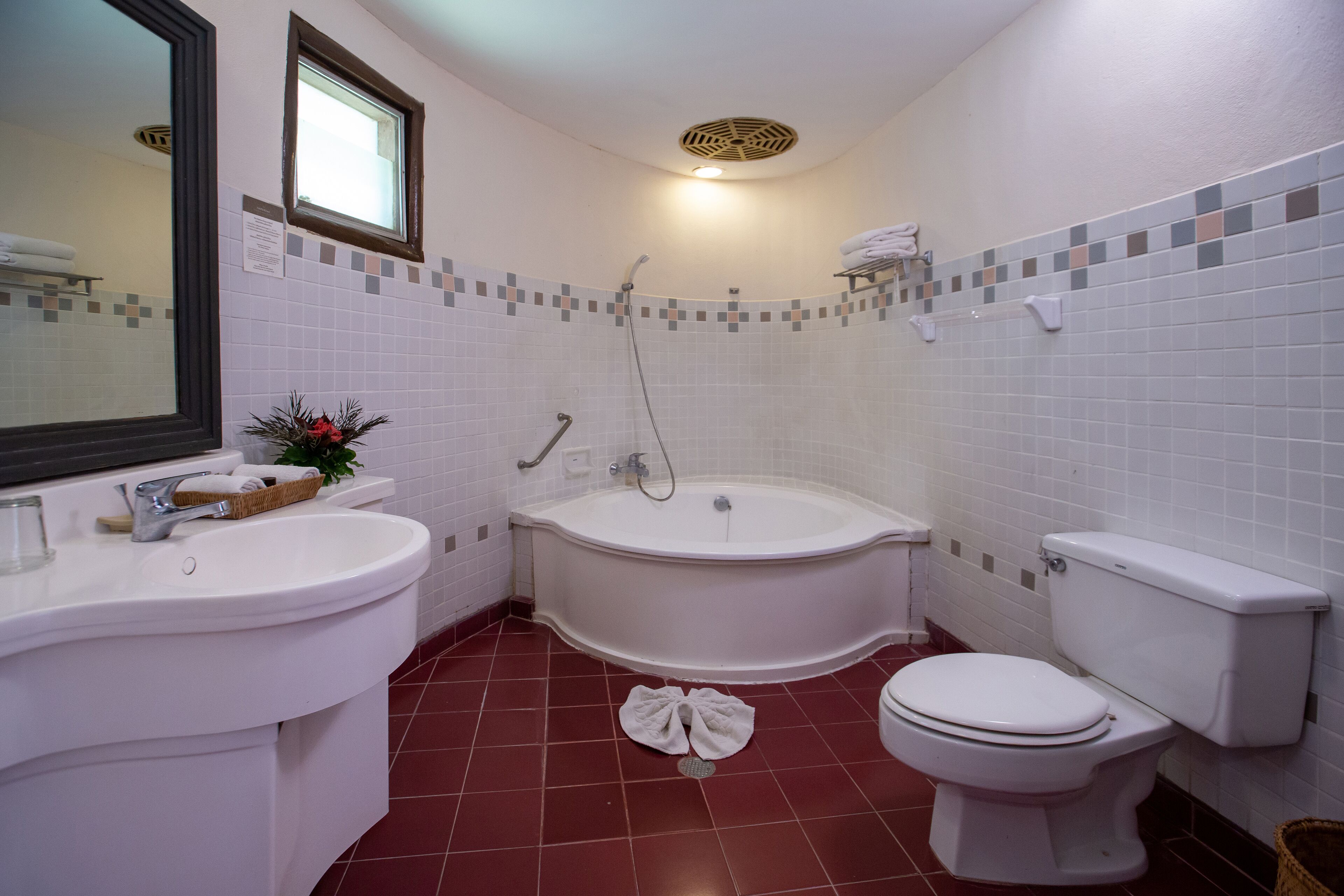A bathroom with a sink, toilet, and bathtub.