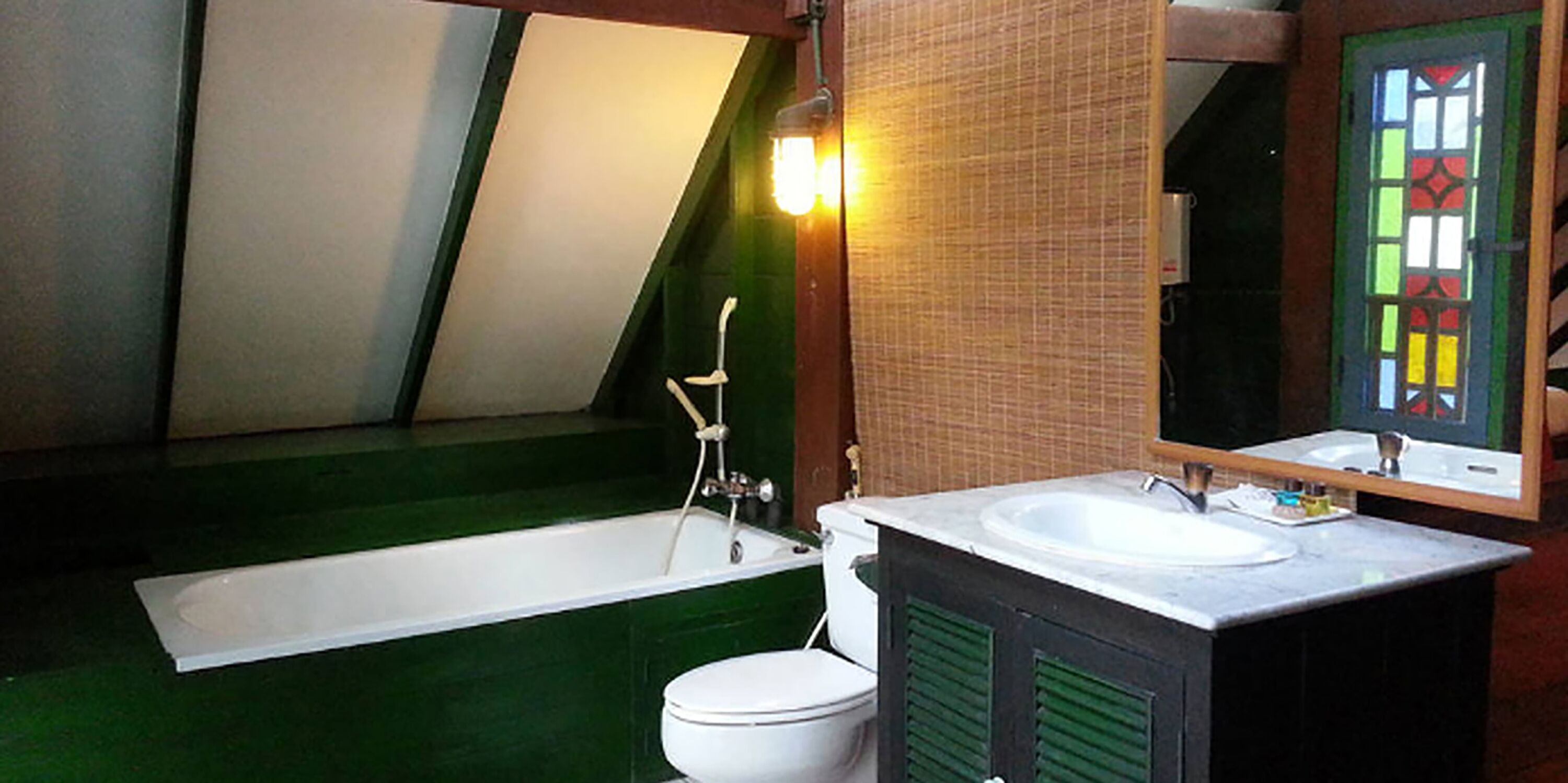 A bathroom with a bathtub, toilet, and sink.
