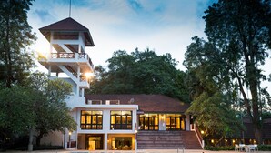 A hotel with a swimming pool, a tower, and a well-maintained garden. - The Imperial Chiang Mai Resort & Sports Club (Mae Rim)
