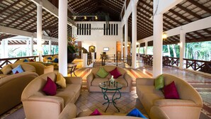 A spacious lobby with high ceilings, multiple seating areas, and a central staircase. - The Imperial Chiang Mai Resort & Sports Club (Mae Rim)