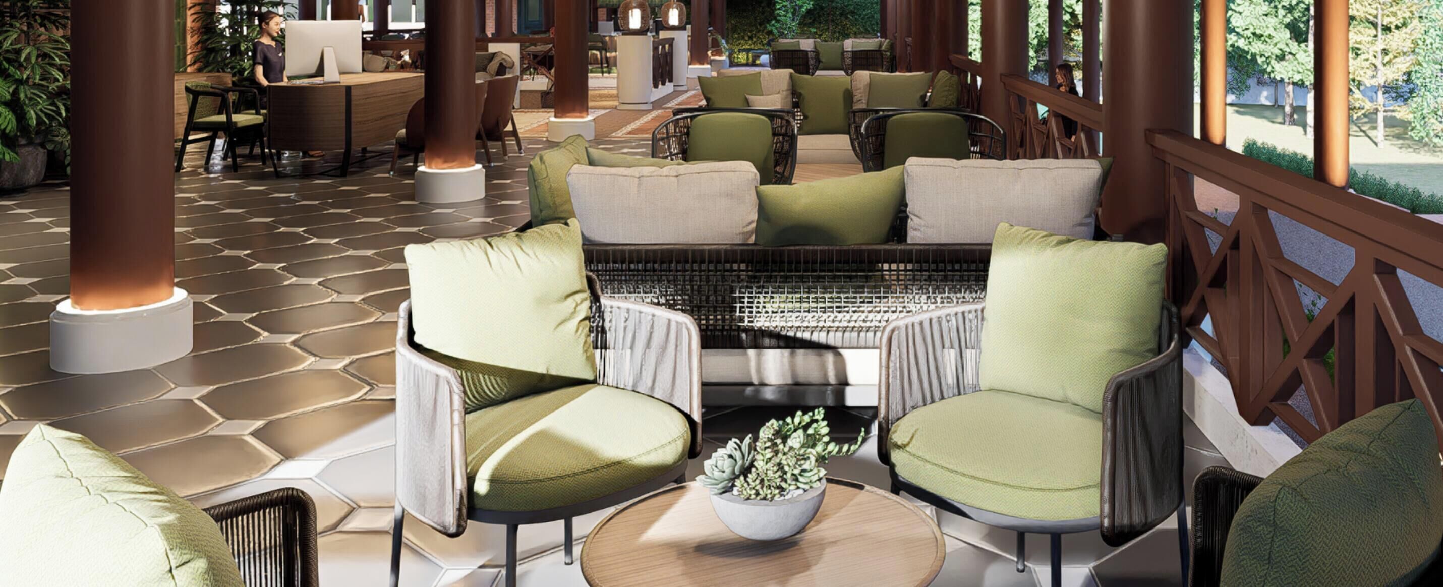 A covered outdoor seating area with green cushioned chairs, a central fire feature, and a potted plant.