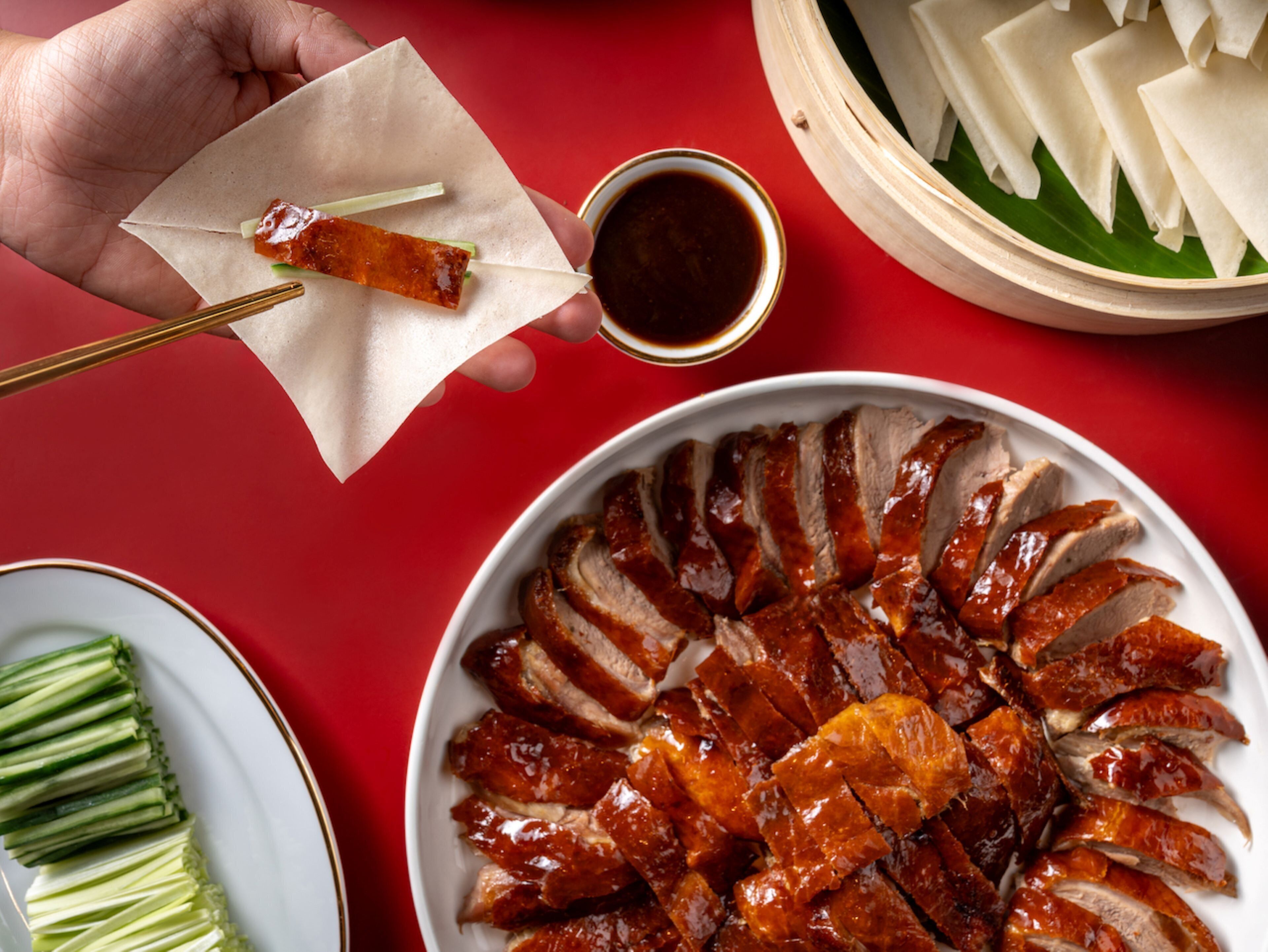 A plate of sliced roasted duck arranged in a circular pattern.
