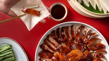 A plate of sliced roasted duck arranged in a circular pattern.