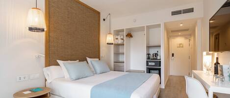 A modern bedroom with a bed, bedside tables, a desk, and a wardrobe.