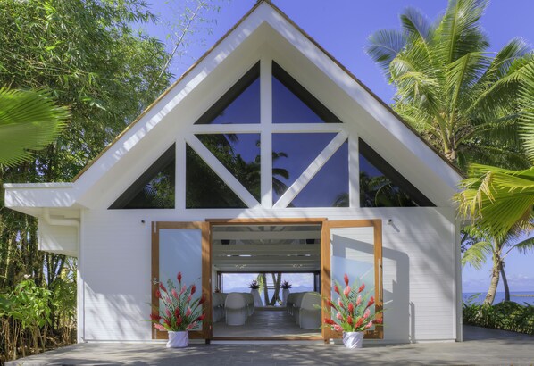 A modern house with a triangular roof, large windows, and a covered porch with seating. - The Pearl Resort & Spa (Pacific Harbour)