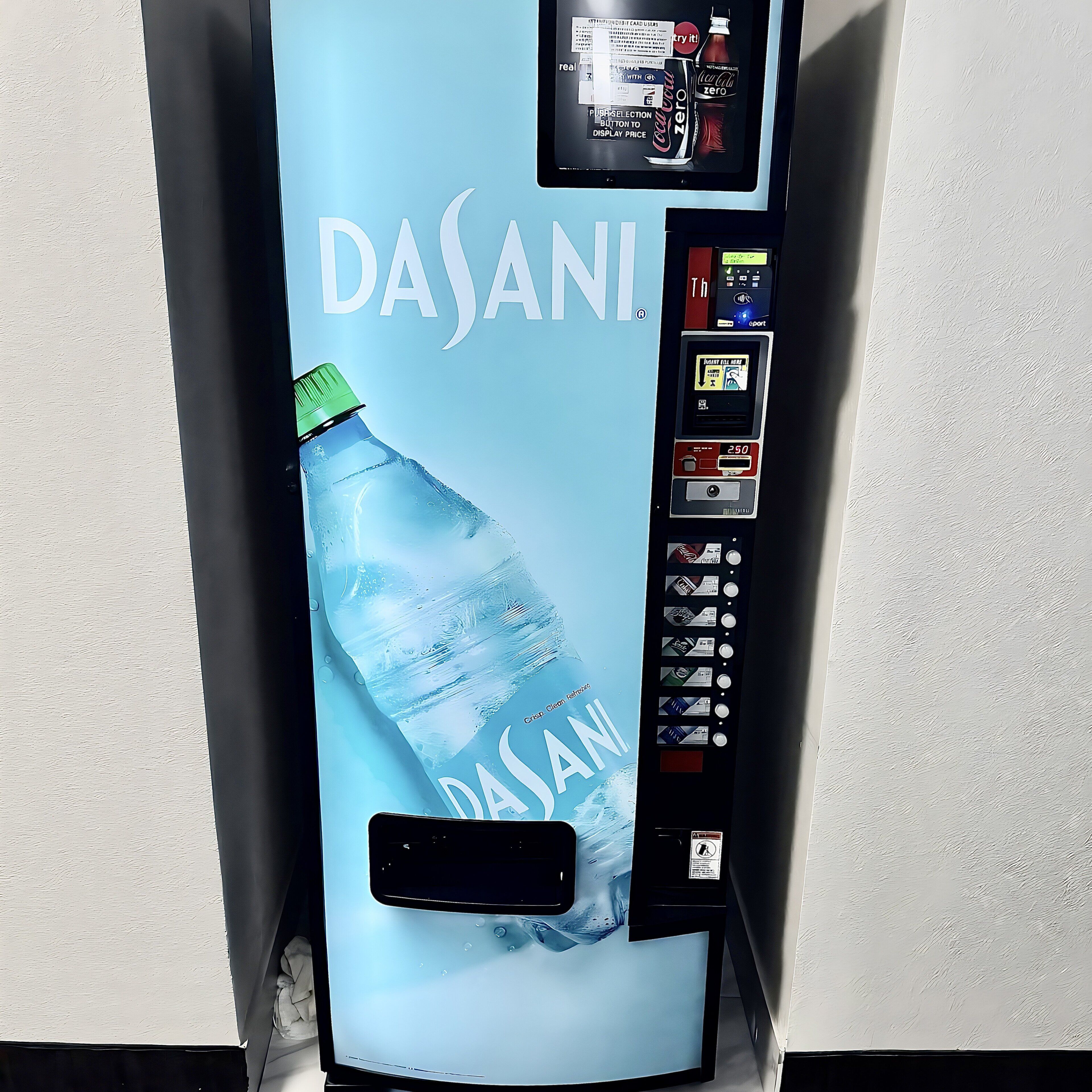 A Dasani water dispenser with a digital payment screen and a selection of beverages.