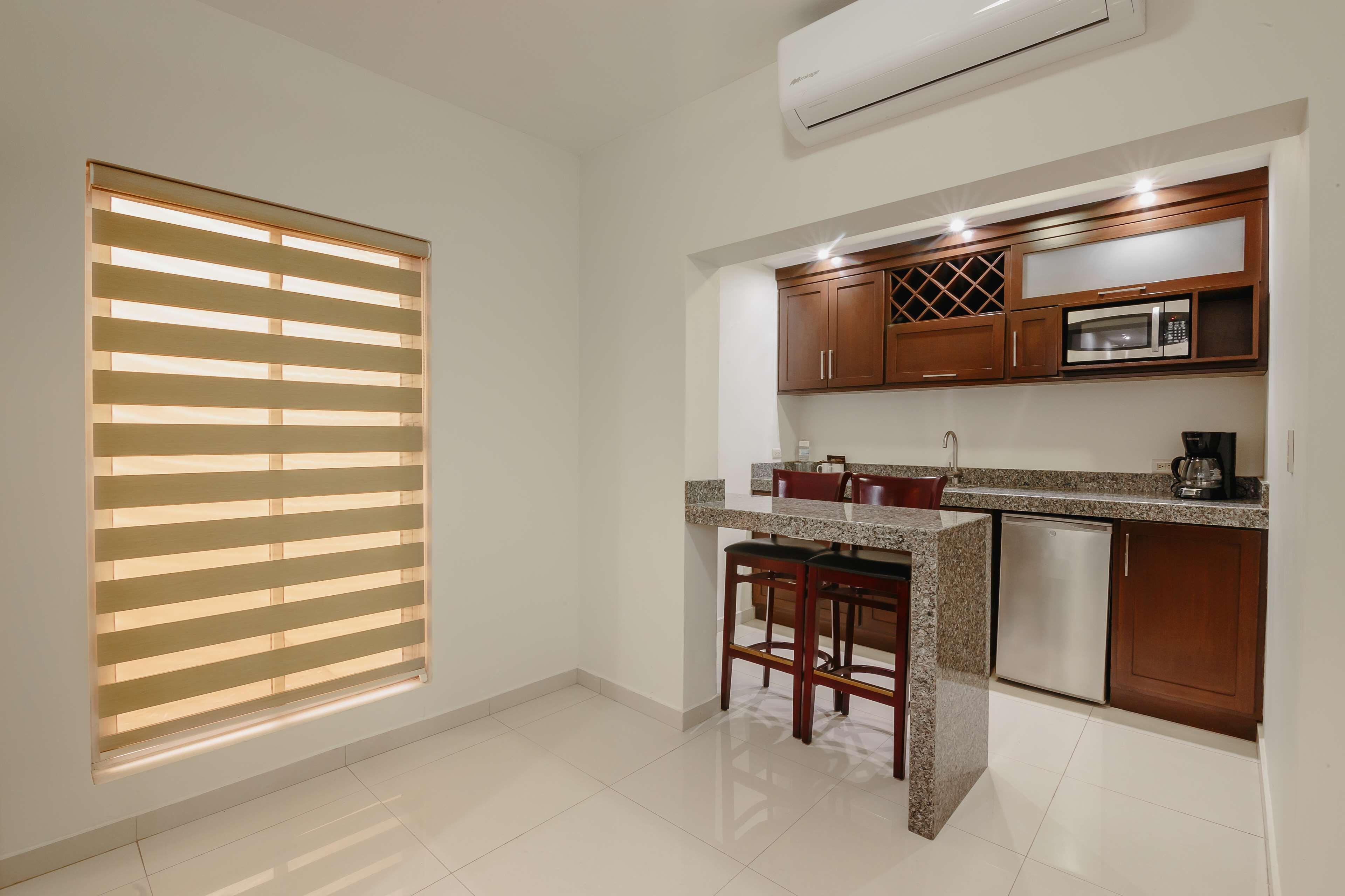 A kitchen with wooden cabinets, a microwave, and a dishwasher.