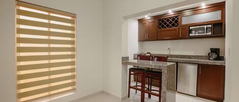 A kitchen with wooden cabinets, a microwave, and a dishwasher.