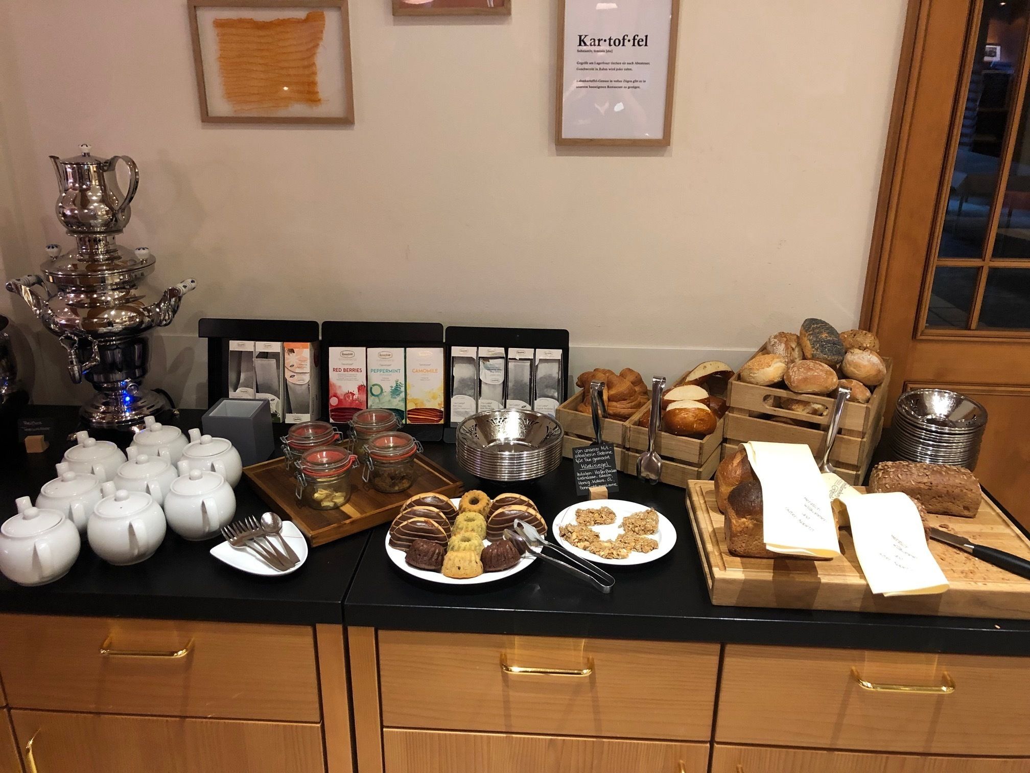 A buffet with various food items, including pastries, cookies, and a selection of beverages.