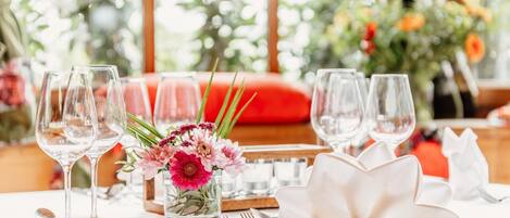 A table set for dining with clear glassware, a white napkin, and a floral centerpiece.