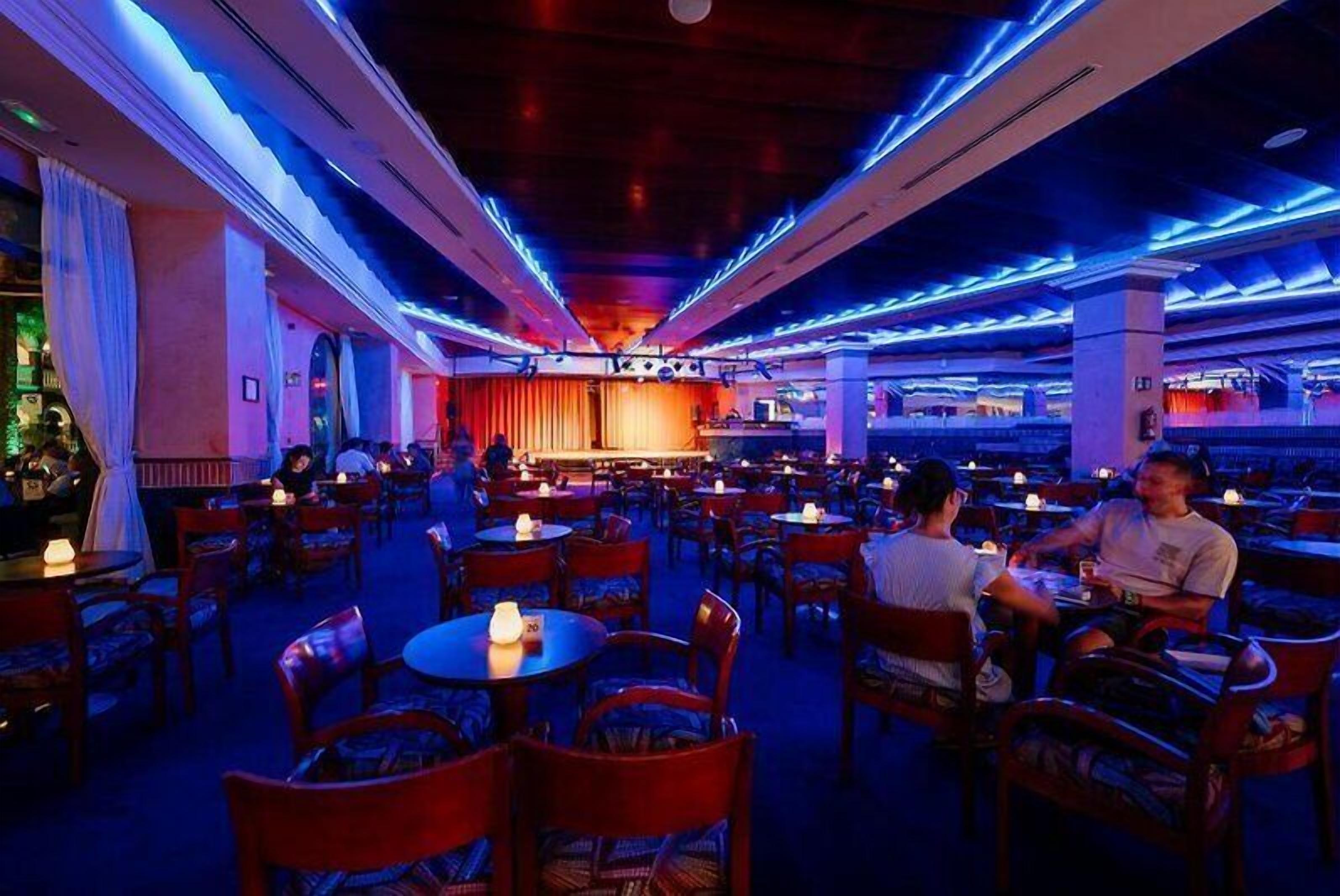 A restaurant with tables and chairs arranged for dining.