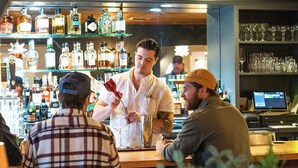 A bar area with wooden ceiling, shelves with bottles, and a bar counter. - Sun Lodge near Manchester VT, Ascend Collection Hotel (Peru)