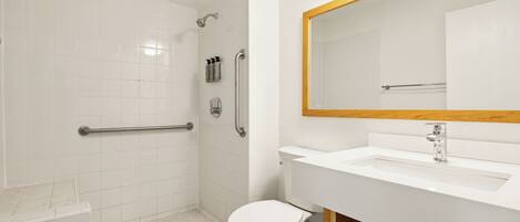 A modern bathroom with a shower, toilet, and sink.