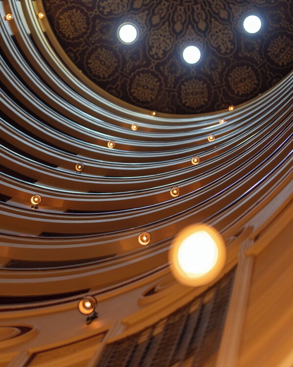 A spiral staircase with a patterned ceiling and recessed lighting. - Rosewood Jeddah (Jeddah)