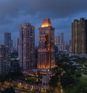 A modern high-rise building with a distinctive pyramid-shaped top, surrounded by other tall buildings in a cityscape. - ITC Grand Central, a Luxury Collection Hotel, Mumbai (Mumbai)