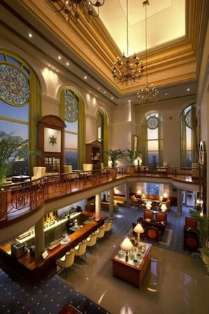 A grand lobby with a bar area, seating, and a staircase leading to an upper level. - ITC Grand Central, a Luxury Collection Hotel, Mumbai (Mumbai)