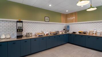 A modern kitchen with a coffee station, a milk station, and a sign that says "Delight".