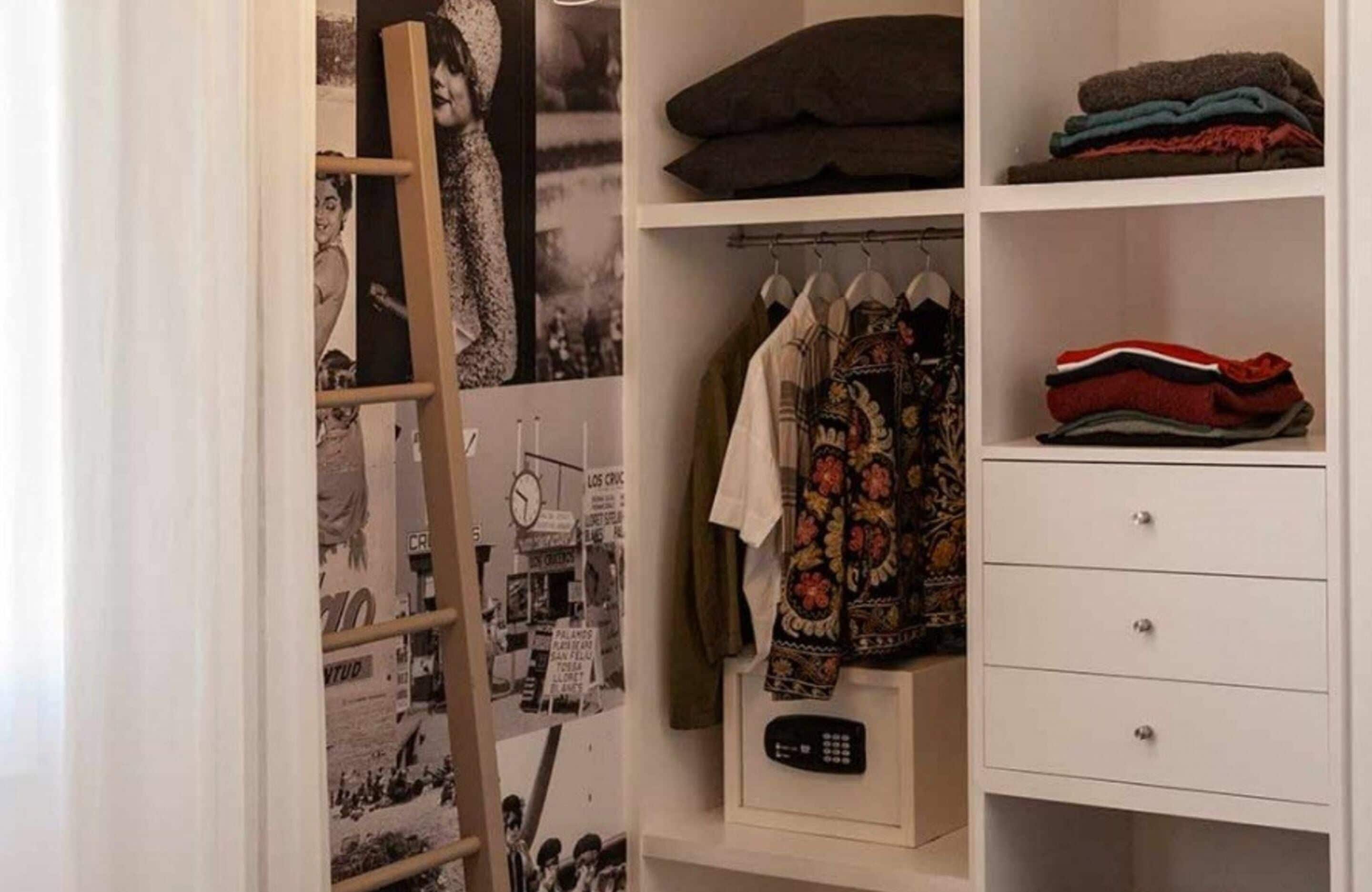 Ein Schrank mit Regalen, einer Kleiderstange und Schubladen.