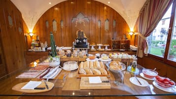 A breakfast buffet with various food items and a coffee machine.
