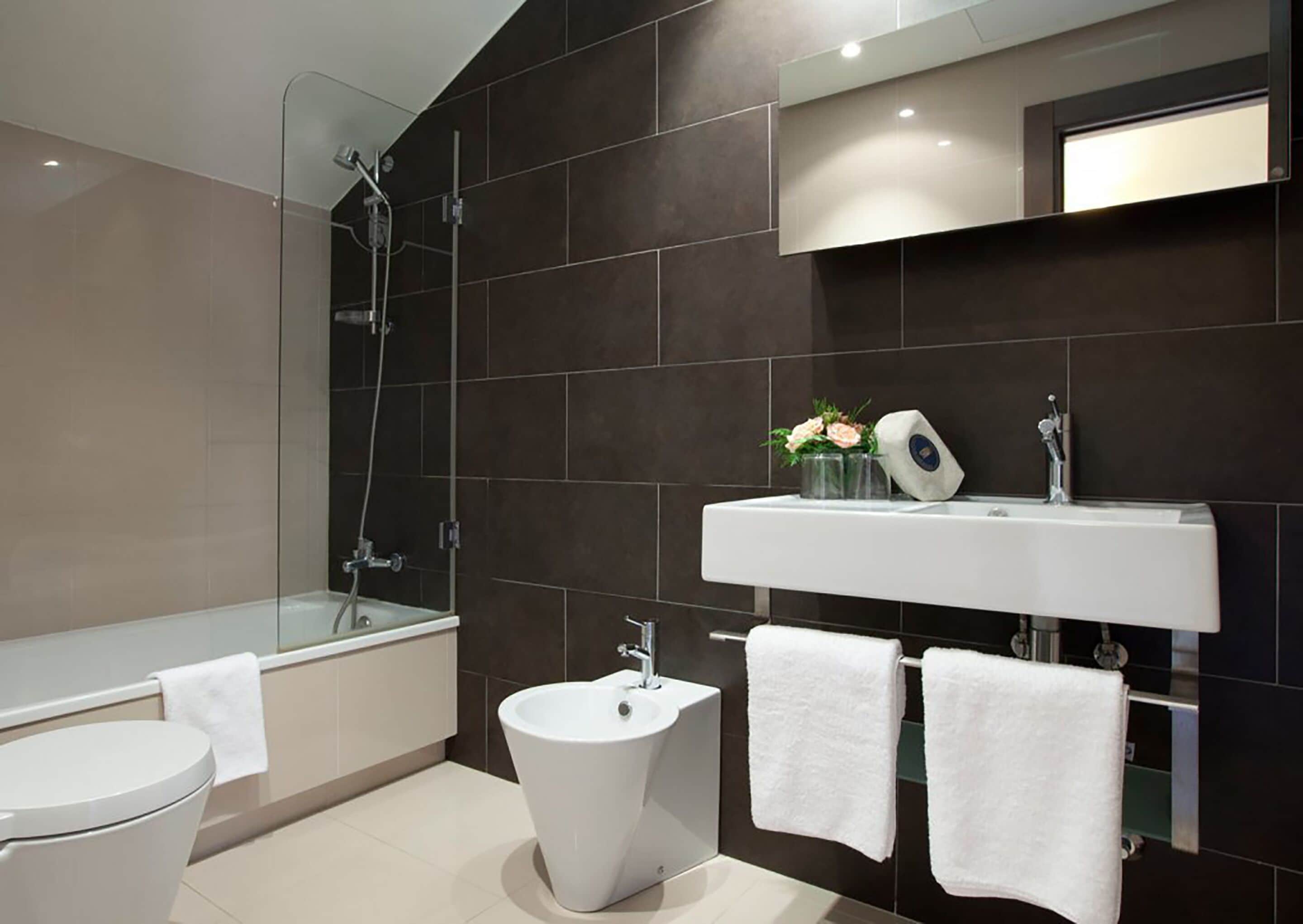 designer toiletries, hair dryer, bidet, towels