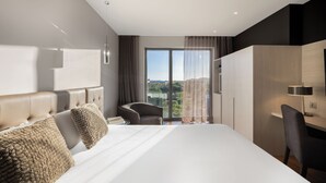 A modern hotel room with a large bed, a desk, and a chair. - Hotel SB BCN Events 4 Sup (Castelldefels)