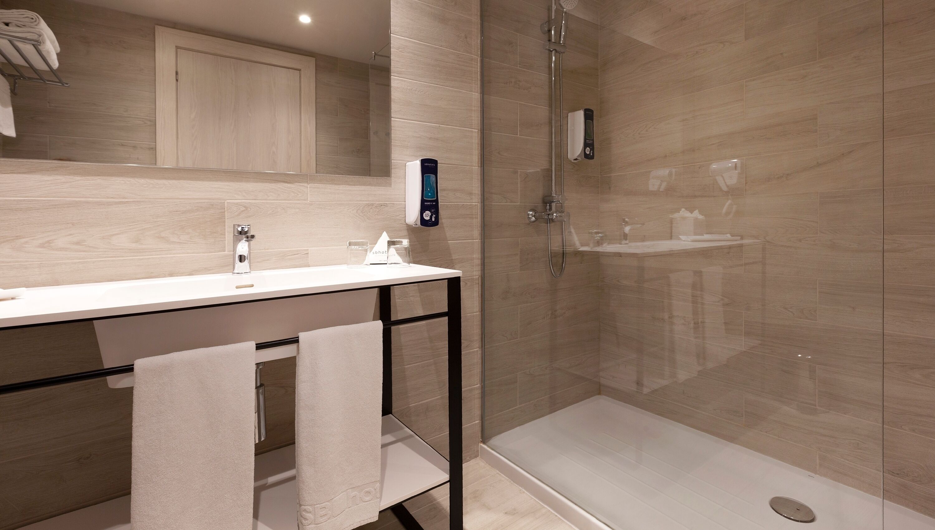 designer toiletries, hair dryer, towels, soap