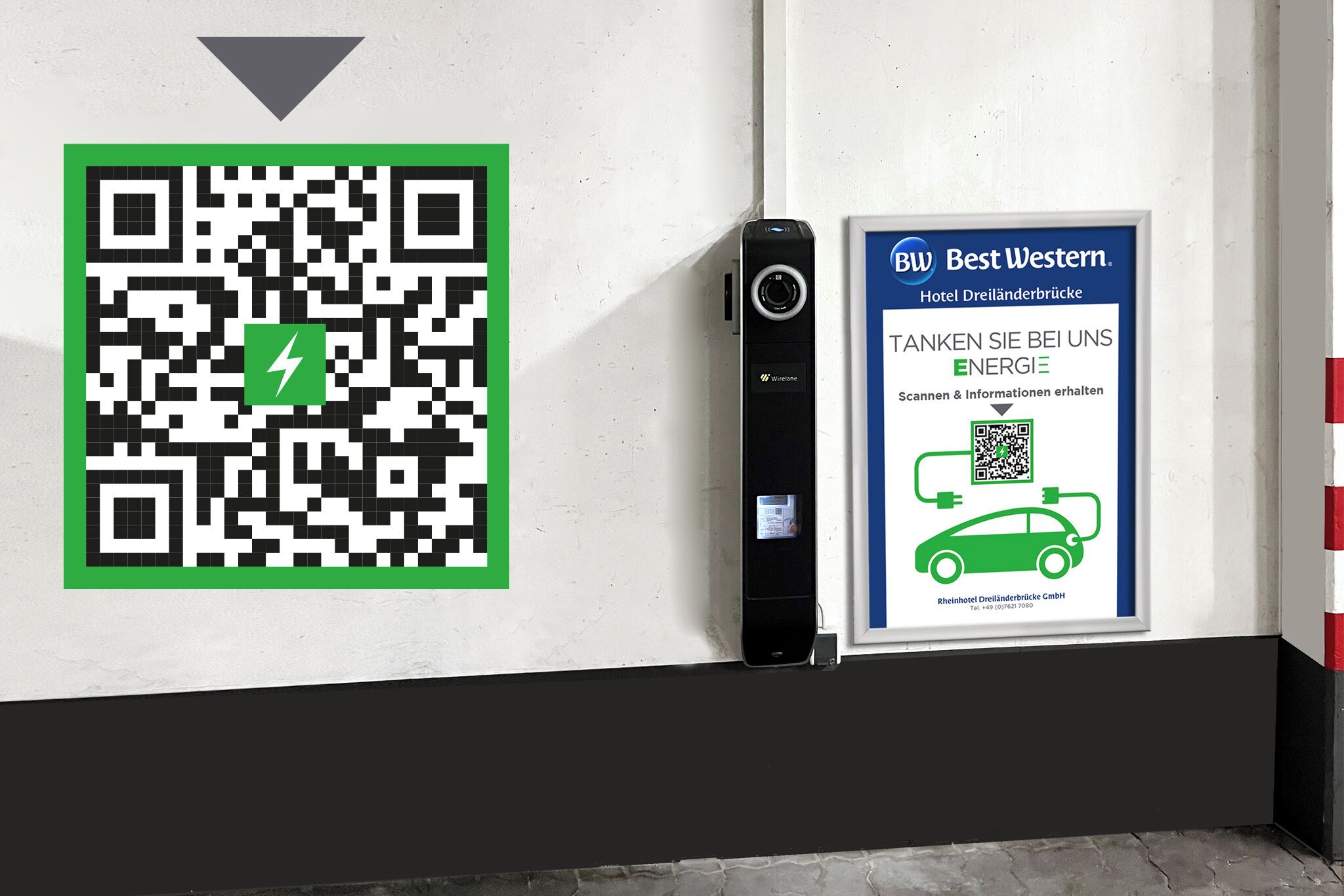 A QR code and a sign for Best Western Hotel Dreiländerbrücke with a car charging station.