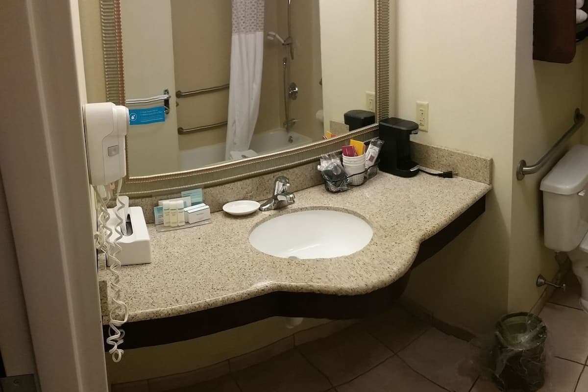 A bathroom with a sink, toilet, and bathtub.