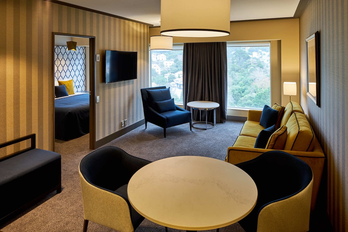 Premier Suite, 1 King Bed | Living room | 40-inch flat-screen TV with cable channels, TV, iPad