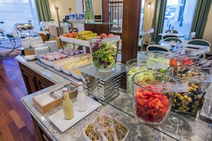 A buffet with various food items and beverages.