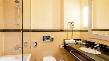 A modern bathroom with a bathtub, toilet, and sink.