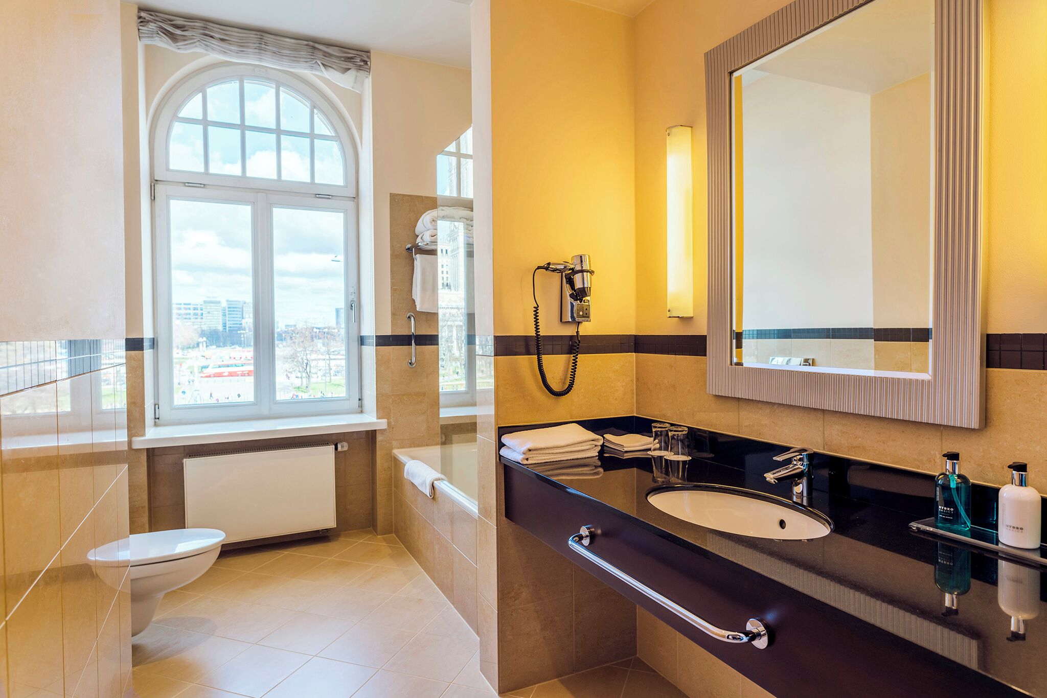 combined shower/bathtub, designer toiletries, hair dryer, towels