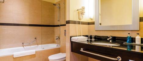 A bathroom with a bathtub, toilet, and sink.