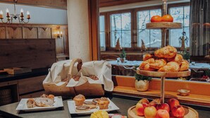 A buffet setup with various baked goods and fruits. - Hotel Kaiser in Tirol (Scheffau am Wilden Kaiser)