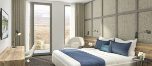 A modern hotel room with a large bed, a desk, and a chair. There is a view of a desert landscape through the windows.