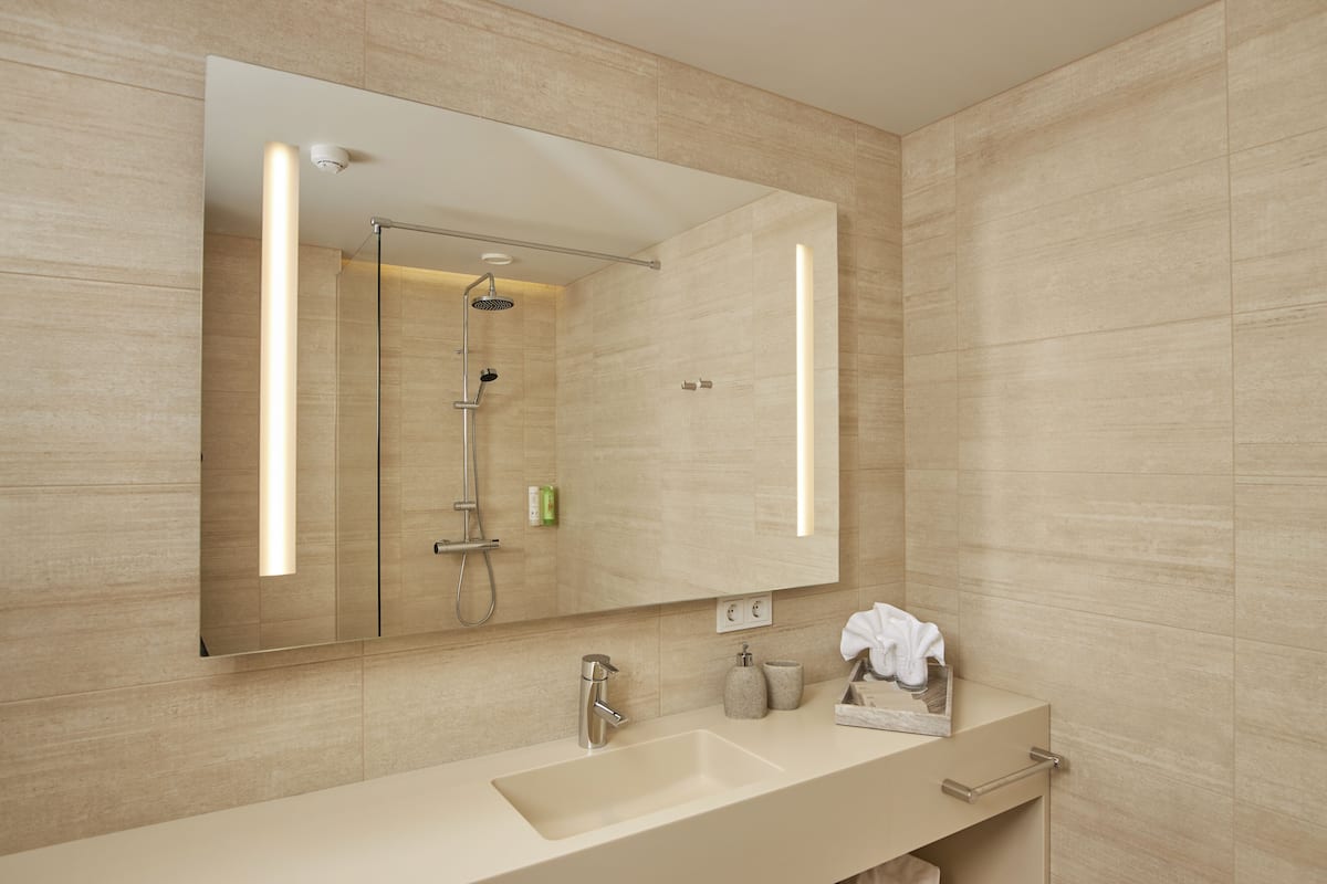 suite | bathroom | shower, rainfall showerhead, hair dryer, towels
