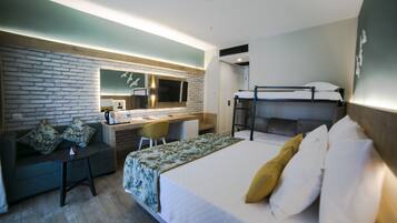 A hotel room with a bunk bed, a desk with a chair, a sofa, and a small table.