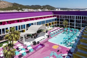 A hotel with a rooftop pool area, multiple balconies, and a view of the surrounding landscape. - Ibiza Rocks Hotel (Sant Antoni de Portmany)