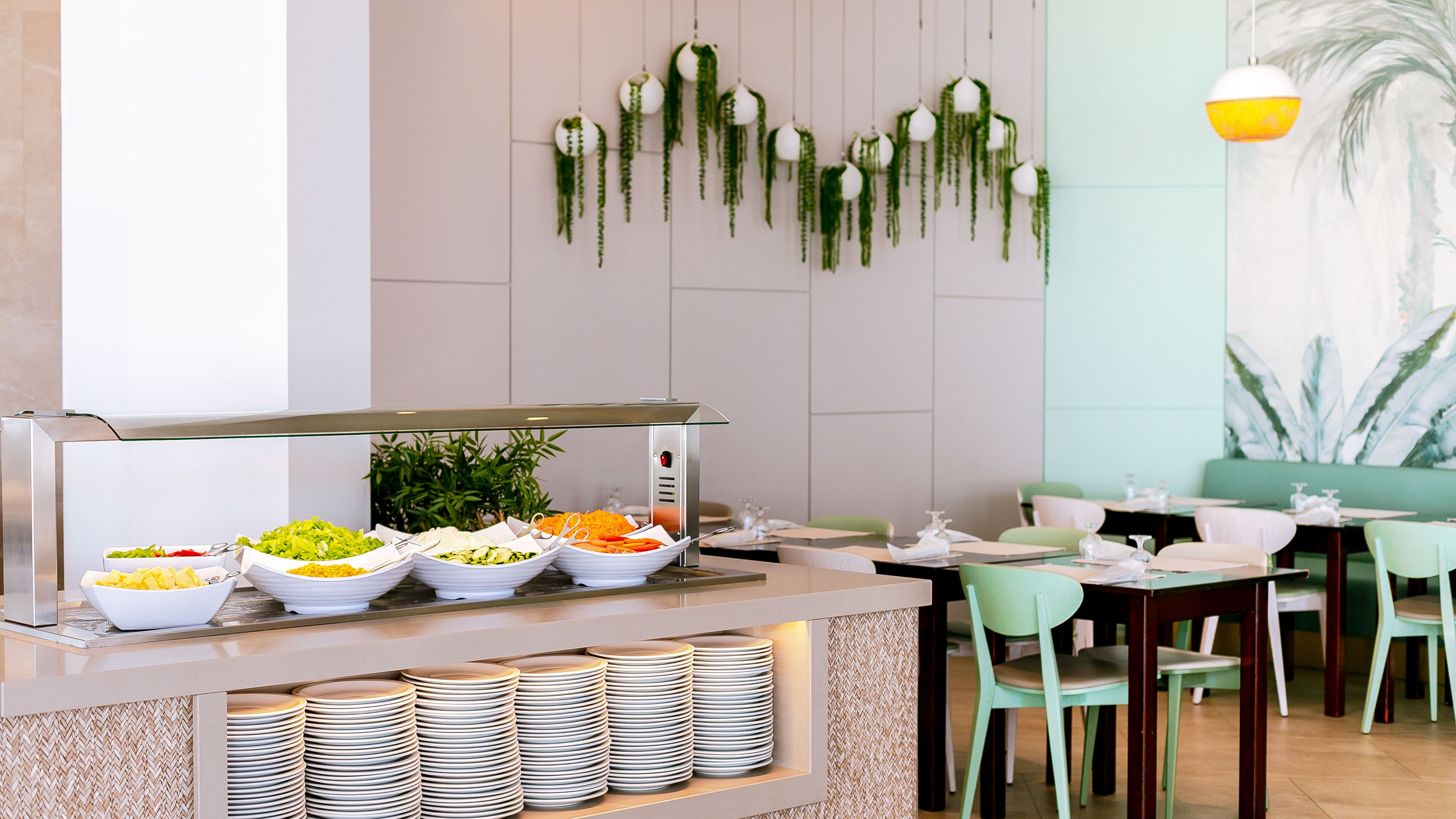 A buffet area with various food options, a coffee machine, and a seating area with tables and chairs.