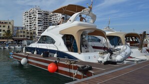 A marina with a white yacht docked at the pier. - Hotel Marfil (Sant Antoni de Portmany)