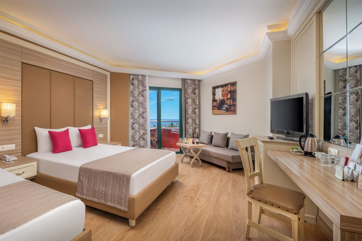Standard Room, Partial Sea View | Minibar, in-room safe, soundproofing, free cribs/infant beds