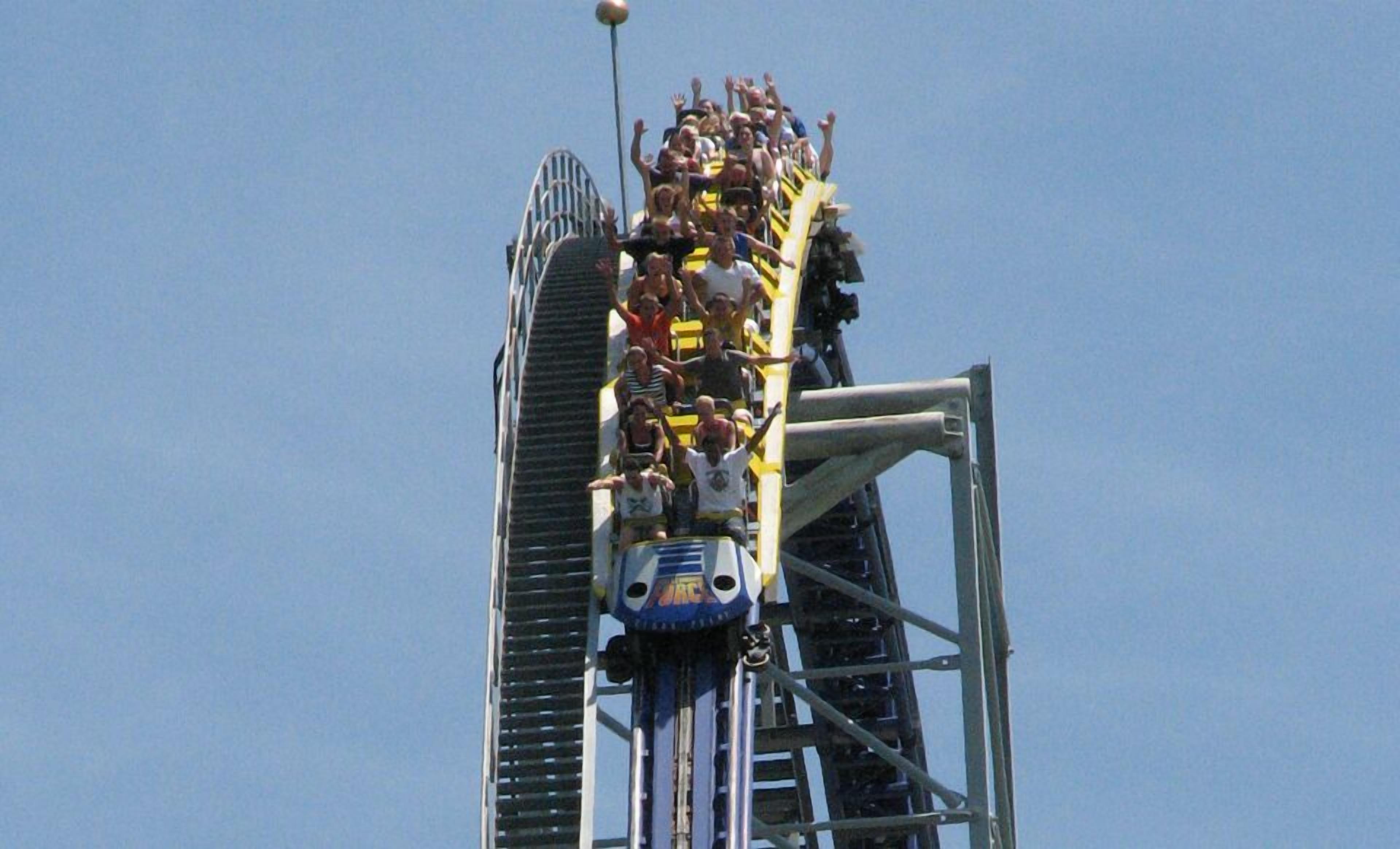 A roller coaster with multiple cars and passengers.